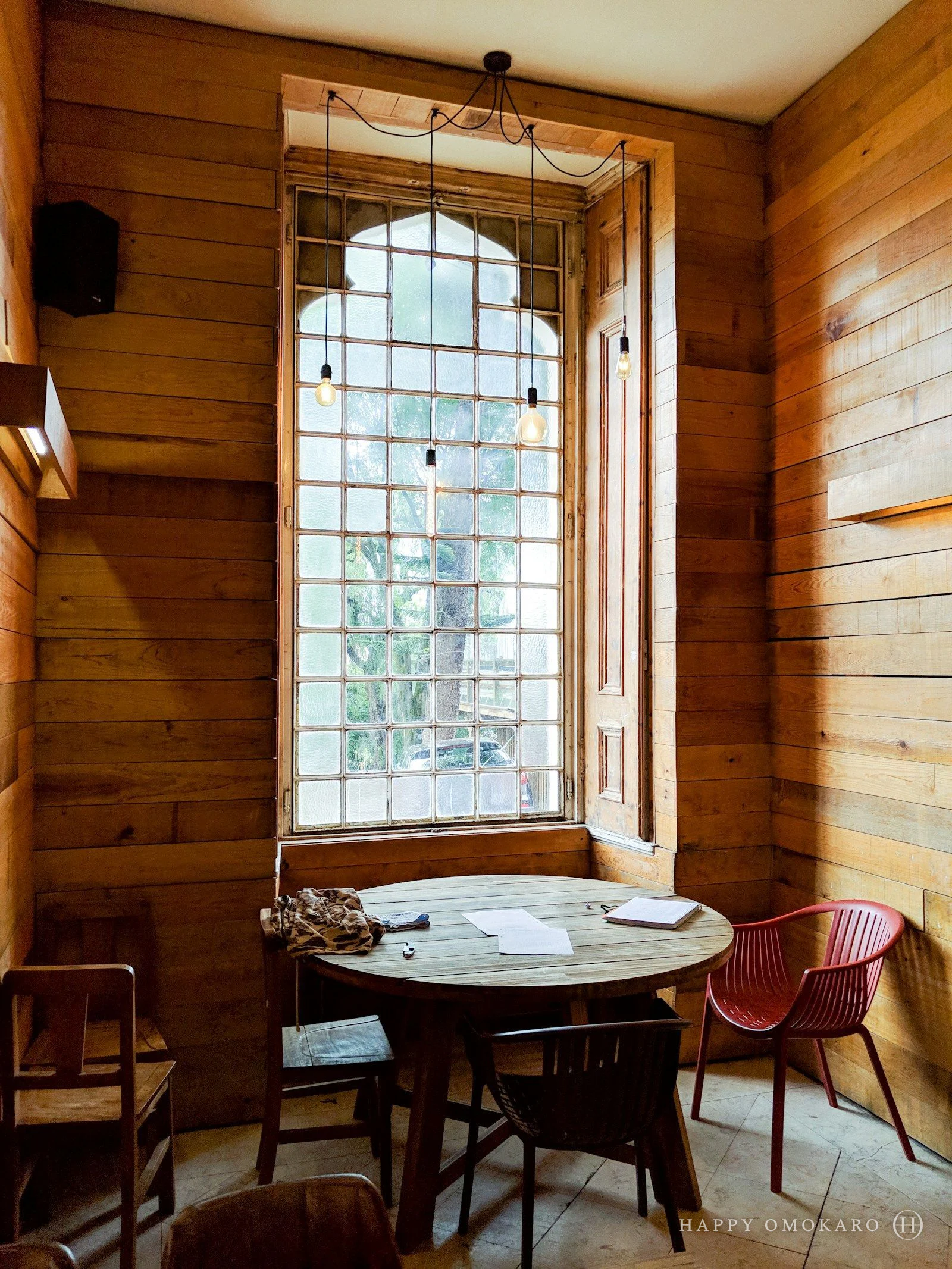 An empty dining room with a French window open to the garden