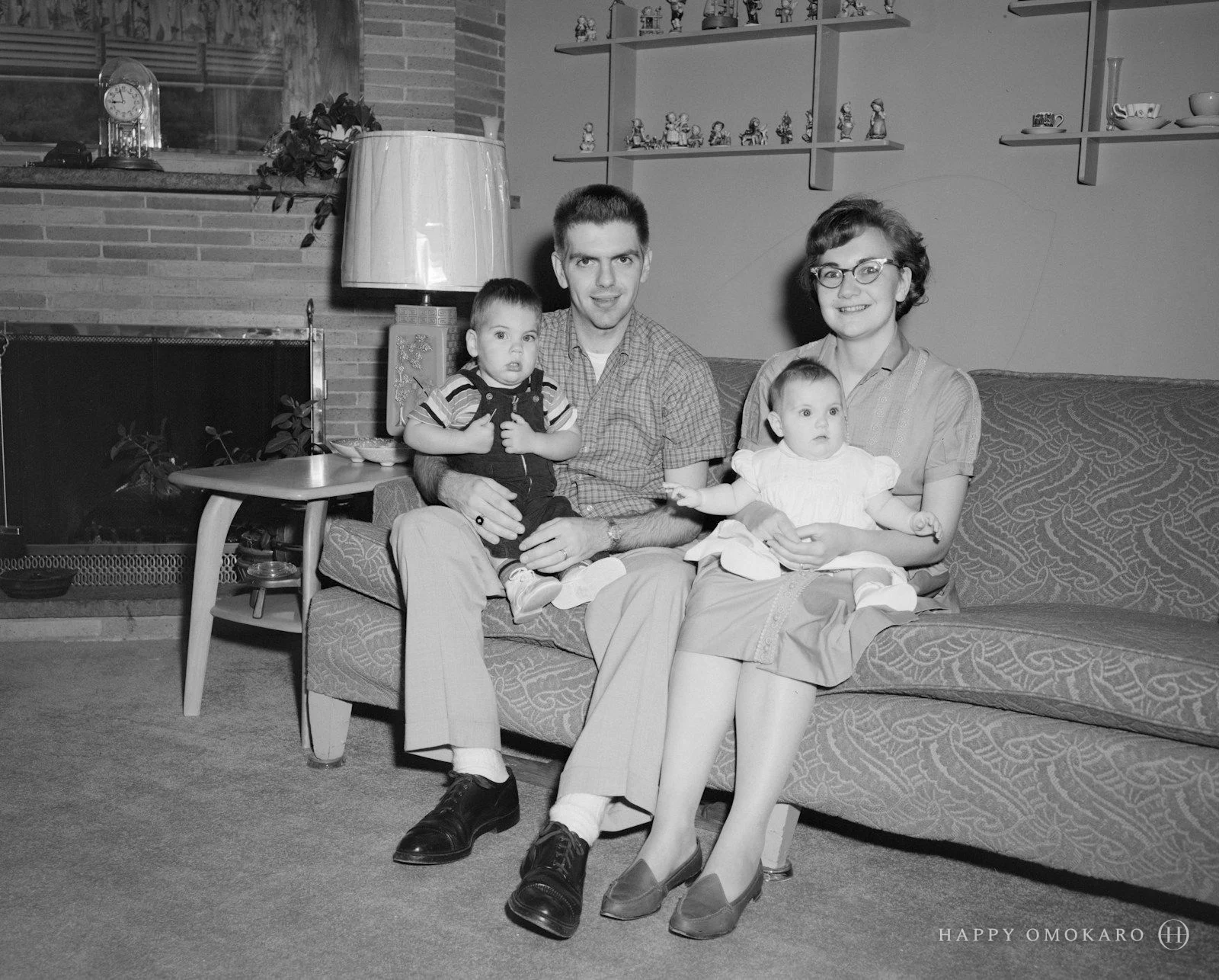 An old grayscale photograph of two boys sitting together on a couch
